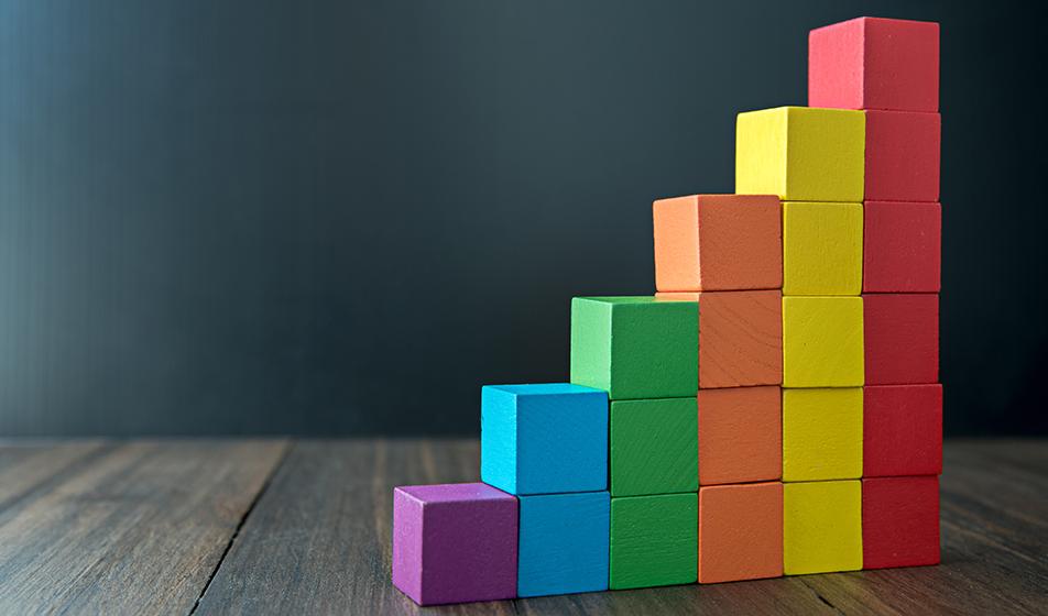 Different coloured blocks (in colours of the rainbow) stack up against each other, each row at an increasing height.